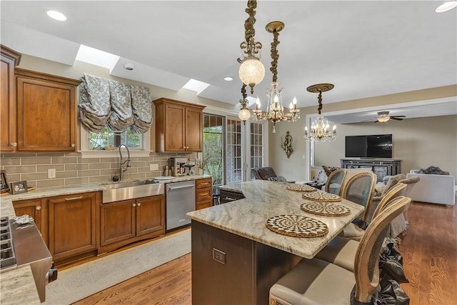 117 Majestic Dr, Adams Twp, PA 16046 - kitchen featuring a sink, dishwasher, a kitchen breakfast bar, open floor plan, and a chandelier