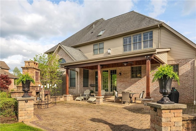 117 Majestic Dr, Adams Twp, PA 16046 - back of property with brick siding, a patio area, and a shingled roof