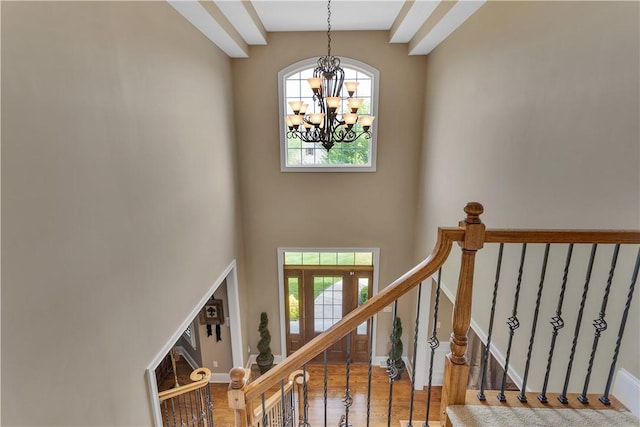 117 Majestic Dr, Adams Twp, PA 16046 - stairs with a chandelier, plenty of natural light, wood finished floors, a high ceiling, and baseboards