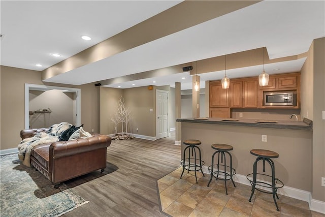 117 Majestic Dr, Adams Twp, PA 16046 - living area with baseboards, light wood finished floors, recessed lighting, and bar with sink