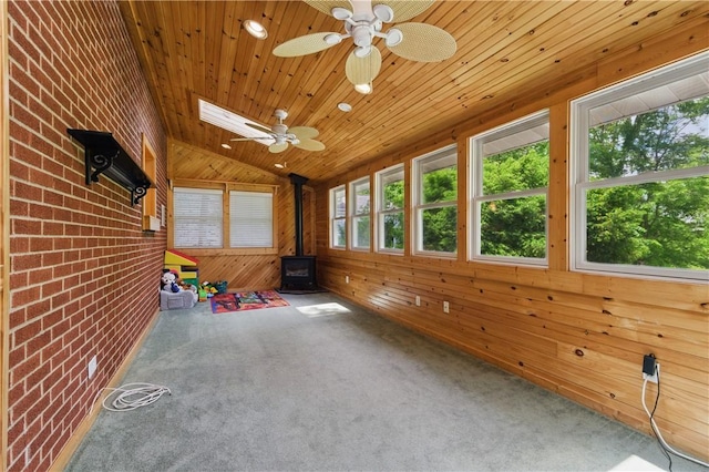 156 Carnation Ave, Ross Twp, PA 15229 - unfurnished sunroom with a wood stove, lofted ceiling, and a skylight