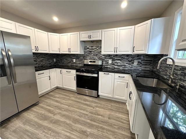94 Lenox St, Uniontown, PA 15401 - kitchen with stainless steel appliances, a sink, white cabinetry, tasteful backsplash, and recessed lighting