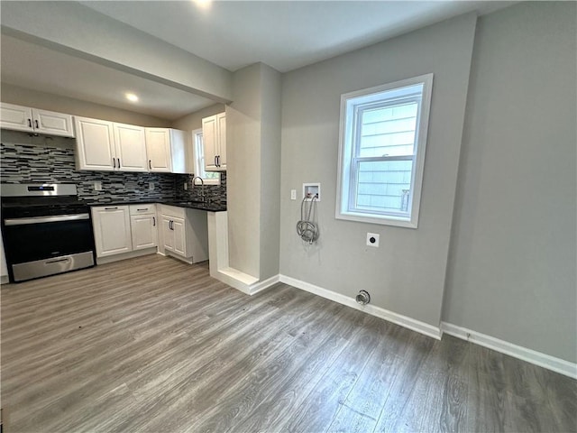 94 Lenox St, Uniontown, PA 15401 - kitchen featuring stainless steel range with gas stovetop, dark countertops, wood finished floors, and baseboards