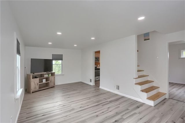 622 Ascension Dr, West Mifflin, PA 15122 - unfurnished living room with light wood-type flooring, stairs, recessed lighting, and baseboards