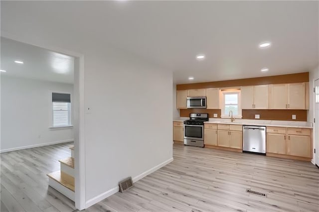622 Ascension Dr, West Mifflin, PA 15122 - kitchen featuring stainless steel appliances, light wood-type flooring, light countertops, a sink, and recessed lighting