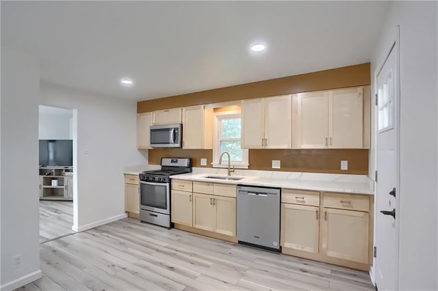 622 Ascension Dr, West Mifflin, PA 15122 - kitchen with stainless steel appliances, a sink, light wood-type flooring, light countertops, and recessed lighting