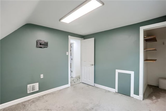 622 Ascension Dr, West Mifflin, PA 15122 - unfurnished bedroom featuring a spacious closet, carpet floors, vaulted ceiling, baseboards, and a closet
