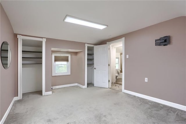622 Ascension Dr, West Mifflin, PA 15122 - unfurnished bedroom featuring two closets, light colored carpet, baseboards, and vaulted ceiling
