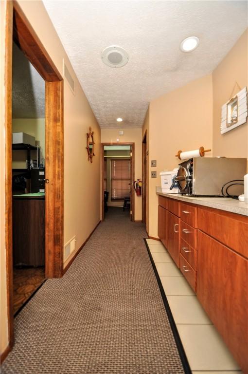 303 S 6th St, West Newton, PA 15089 - hallway with light colored carpet and a textured ceiling