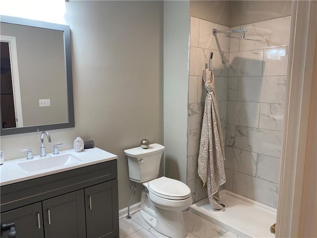 3809 Liberty Ave Unit 307, Lawrenceville, PA 15201 - bathroom featuring vanity, toilet, tiled shower, and baseboards