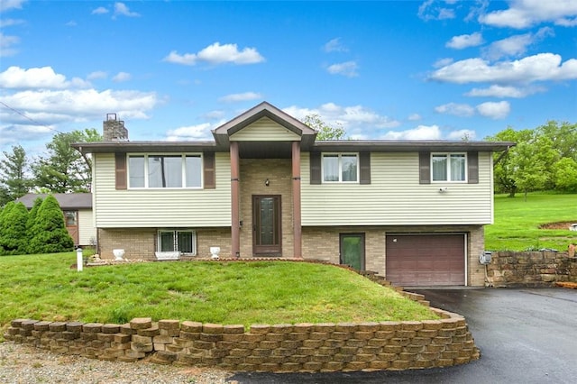 512 Leckrone Highhouse Rd, Pa, PA 15458 - bi-level home with driveway, an attached garage, a chimney, and brick siding