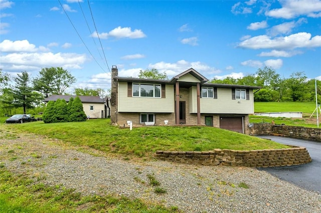 512 Leckrone Highhouse Rd, Pa, PA 15458 - raised ranch featuring asphalt driveway, an attached garage, a chimney, and a front lawn