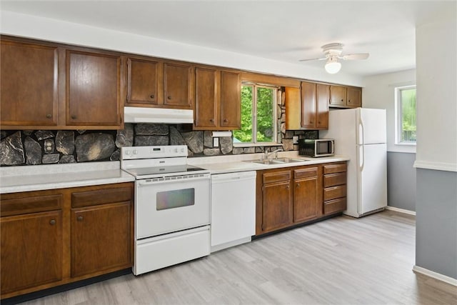 1777 Oblock Rd, Plum Boro, PA 15239 - kitchen featuring white appliances, under cabinet range hood, a sink, and light countertops