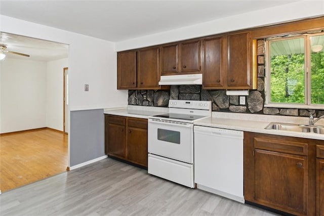 1777 Oblock Rd, Plum Boro, PA 15239 - kitchen with white appliances, under cabinet range hood, light countertops, a sink, and decorative backsplash