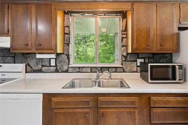 1777 Oblock Rd, Plum Boro, PA 15239 - kitchen featuring white dishwasher, stainless steel microwave, a sink, range hood, and light countertops