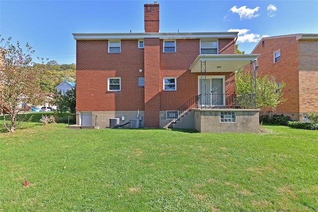 257 Noble Ave, Crafton, PA 15205 - back of property with a lawn, brick siding, and a chimney