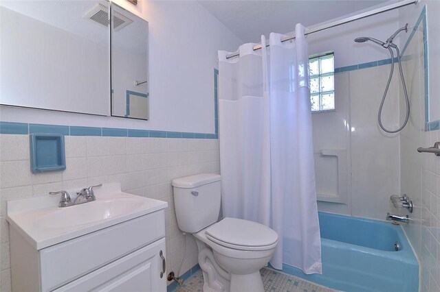 257 Noble Ave, Crafton, PA 15205 - bathroom featuring tile walls, shower / bath combo, toilet, vanity, and a wainscoted wall