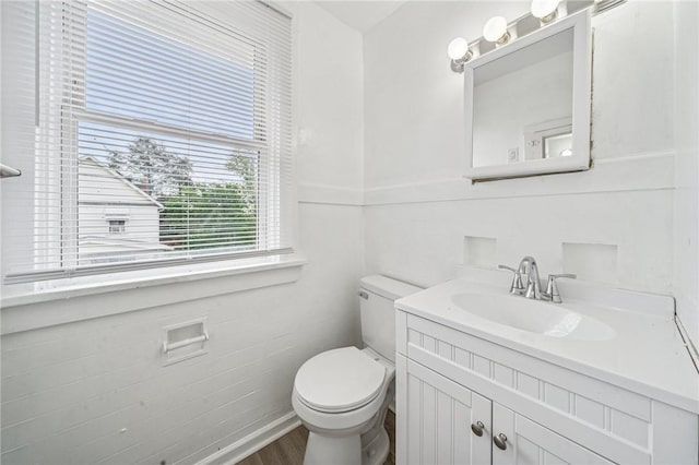 1422 Meadow St, Mckeesport, PA 15132 - half bathroom with toilet, vanity, and wood finished floors
