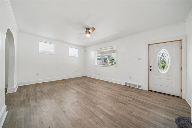 1422 Meadow St, Mckeesport, PA 15132 - foyer featuring a ceiling fan, crown molding, arched walkways, wood finished floors, and baseboards