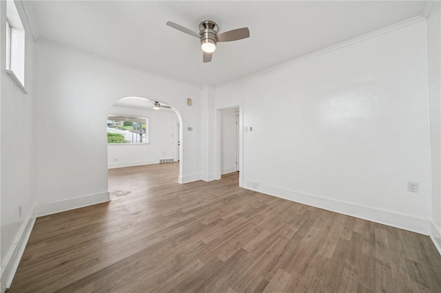 1422 Meadow St, Mckeesport, PA 15132 - unfurnished room featuring a ceiling fan, arched walkways, wood finished floors, crown molding, and baseboards