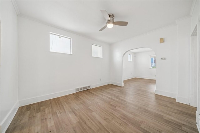 1422 Meadow St, Mckeesport, PA 15132 - spare room featuring arched walkways, crown molding, a ceiling fan, healthy amount of natural light, and light wood-type flooring