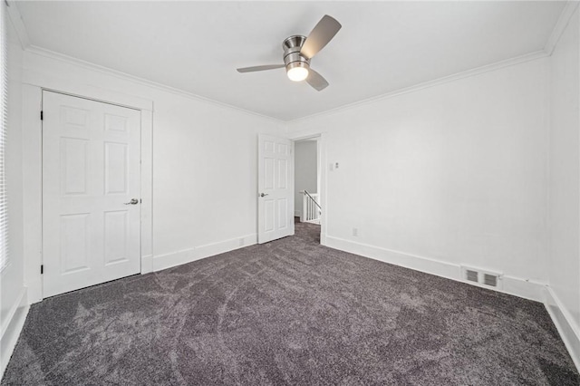 1422 Meadow St, Mckeesport, PA 15132 - unfurnished bedroom with dark colored carpet, ornamental molding, baseboards, and a ceiling fan