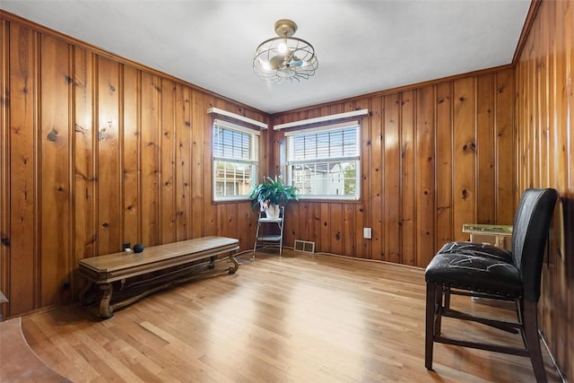 830 W Pike St, Chartiers, PA 15342 - living area featuring light wood-style flooring, wood walls, and a chandelier