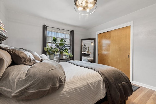 830 W Pike St, Chartiers, PA 15342 - bedroom with light wood finished floors, baseboards, a chandelier, and a closet