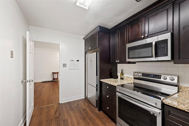 5100 5th Ave Unit 407, Shadyside, PA 15232 - kitchen with stainless steel appliances, dark wood finished floors, decorative backsplash, baseboards, and light stone counters