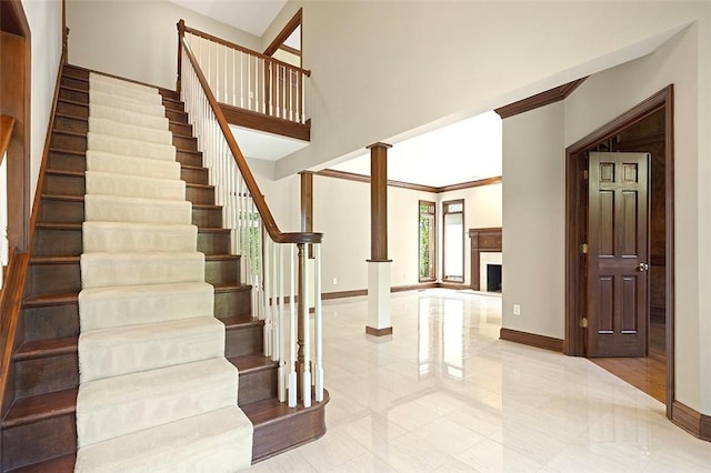 3702 Millstone Ct, Murrysville, PA 15668 - stairs featuring baseboards, a fireplace, and ornamental molding
