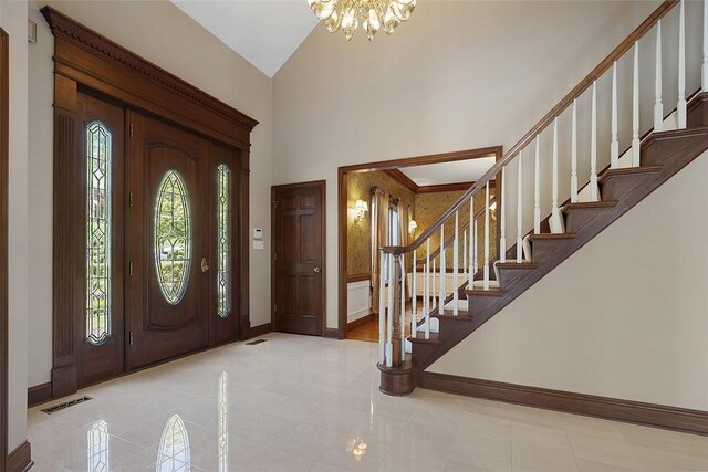 3702 Millstone Ct, Murrysville, PA 15668 - tiled foyer with a chandelier, stairs, baseboards, and a towering ceiling