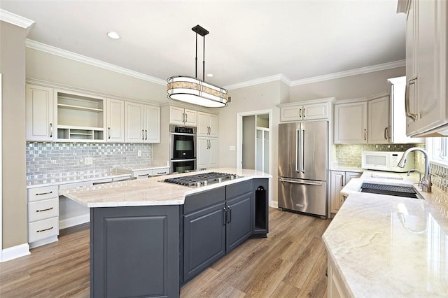 3702 Millstone Ct, Murrysville, PA 15668 - kitchen featuring appliances with stainless steel finishes, a kitchen island, light wood-type flooring, backsplash, and open shelves