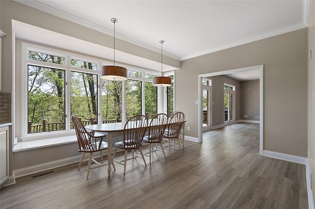 3702 Millstone Ct, Murrysville, PA 15668 - dining space with wood finished floors, baseboards, and crown molding