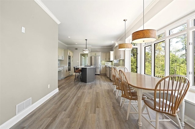 3702 Millstone Ct, Murrysville, PA 15668 - dining room featuring light wood-style floors, baseboards, ornamental molding, and recessed lighting