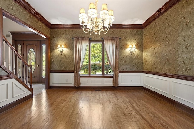 3702 Millstone Ct, Murrysville, PA 15668 - empty room featuring wallpapered walls, a chandelier, a wainscoted wall, wood finished floors, and stairway