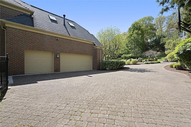 3702 Millstone Ct, Murrysville, PA 15668 - view of side of property featuring decorative driveway, brick siding, a high end roof, and a garage