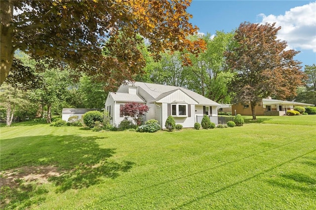 211 Homestead Dr, Middlesex Twp, PA 16059 - view of front facade featuring a front yard, board and batten siding, and view of wooded area