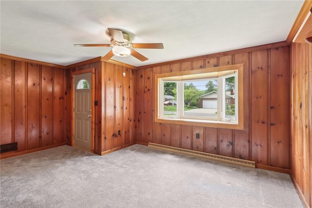 211 Homestead Dr, Middlesex Twp, PA 16059 - carpeted empty room featuring a baseboard heating unit, ceiling fan, wooden walls, baseboards, and crown molding