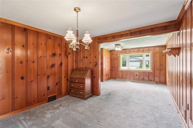 211 Homestead Dr, Middlesex Twp, PA 16059 - empty room with carpet, ceiling fan, wood walls, a chandelier, and baseboard heating
