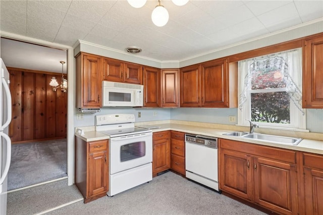 211 Homestead Dr, Middlesex Twp, PA 16059 - kitchen featuring white appliances, a sink, light countertops, and brown cabinetry