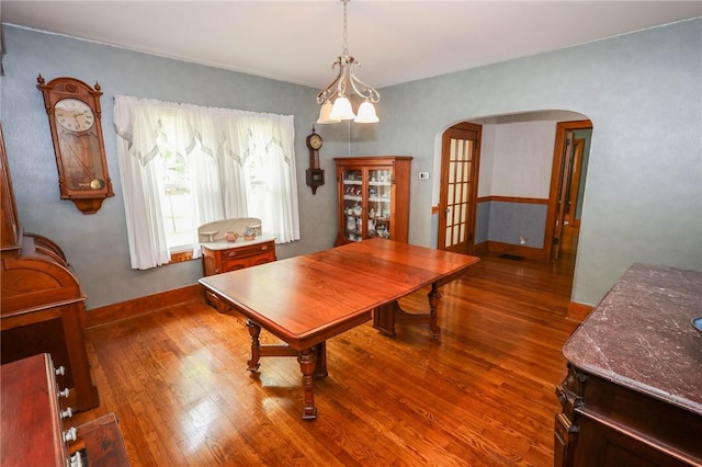 120 S Shenango St, Mercer Boro Mer, PA 16137 - dining room featuring arched walkways, wood finished floors, and baseboards