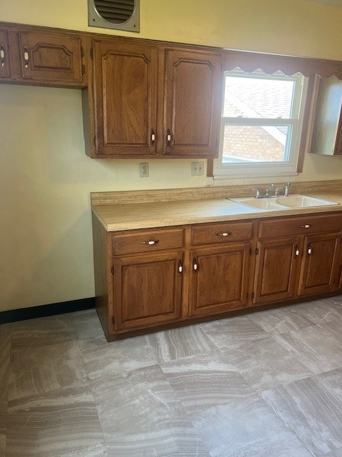 525 Glade Mill Run, Middlesex Twp, PA 16059 - kitchen featuring a sink, brown cabinets, and light countertops
