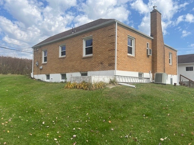 525 Glade Mill Run, Middlesex Twp, PA 16059 - rear view of property featuring a chimney, central AC, a yard, and brick siding