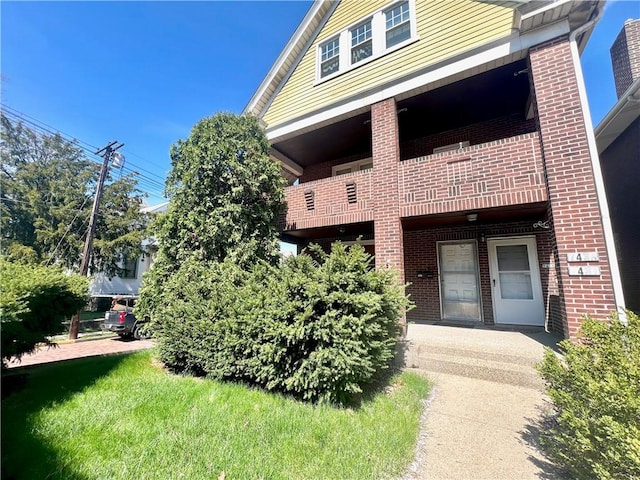 7437-7439 Schoyer Ave, Swissvale, PA 15218 - property entrance with brick siding and a balcony