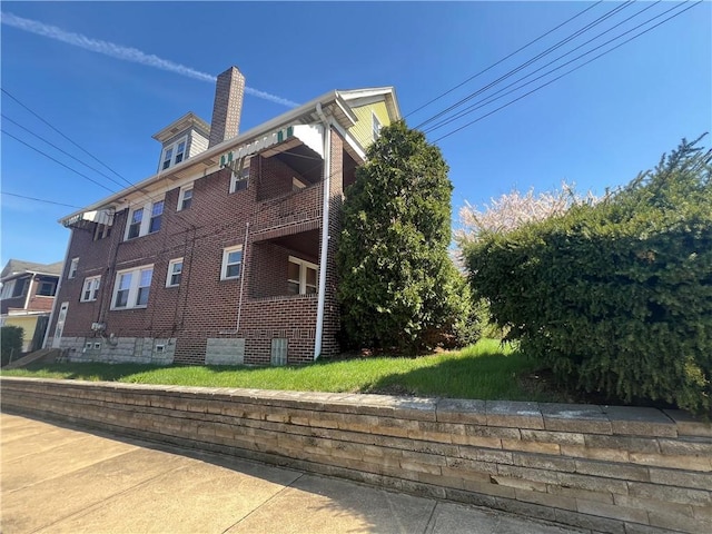 7437-7439 Schoyer Ave, Swissvale, PA 15218 - view of property exterior featuring a chimney, a balcony, and brick siding