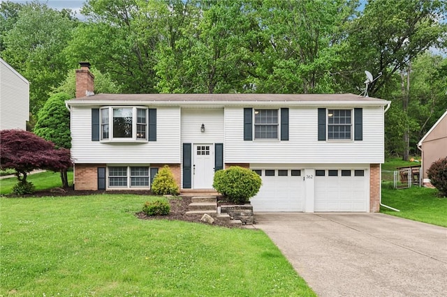 362 Fruitwood Dr, Bethel Park, PA 15102 - split foyer home featuring brick siding, a chimney, driveway, a front lawn, and an attached garage