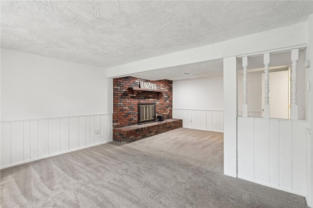 362 Fruitwood Dr, Bethel Park, PA 15102 - unfurnished living room featuring a textured ceiling, carpet flooring, wainscoting, and a brick fireplace