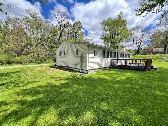 11859 Kammerer Ave, Conneaut Lake Cra, PA 16316 - view of home's exterior with a yard, a wooden deck, and a chimney