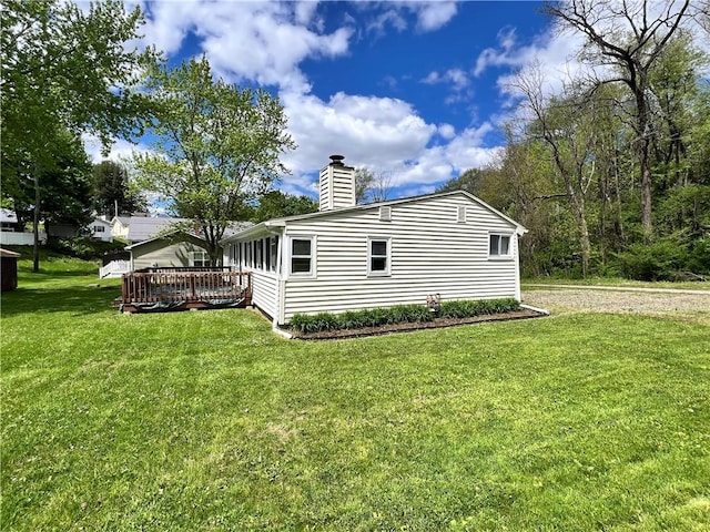11859 Kammerer Ave, Conneaut Lake Cra, PA 16316 - view of side of property featuring a chimney, a wooden deck, and a yard