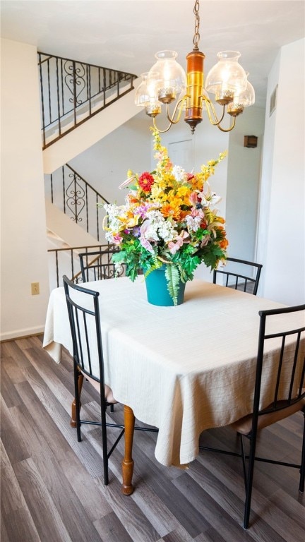 4895 Lucerne Rd, White Twp Ind, PA 15701 - dining area with a chandelier, wood finished floors, baseboards, and stairway